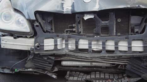 Detail-Of-Car-Damaged-In-Motor-Vehicle-Accident-Parked-In-Garage-Repair-Shop