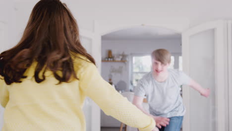 Young-Downs-Syndrome-Couple-Having-Fun-Dancing-At-Home-Together