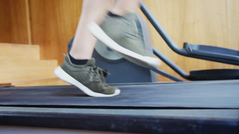 Close-Up-Of-Feet-As-Man-Exercises-Running-On-Treadmill