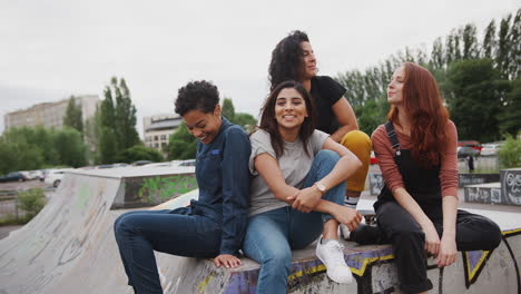 Group-Of-Female-Friends-Posing-For-Photo-On-Camera-In-Urban-Skate-Park