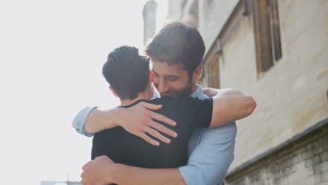 Loving-Male-Gay-Couple-Hugging-Outside-In-City-Street