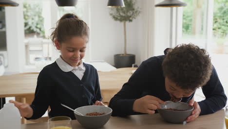 Children-At-Kitchen-Counter-Eating-Sugary-Breakfast-Before-Going-To-School