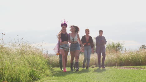 Group-Of-Excited-Young-Female-Friends-Walking-Through-Music-Festival-Site