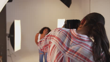 Model-Posing-For-Female-Photographer-In-Studio-Portrait-Session