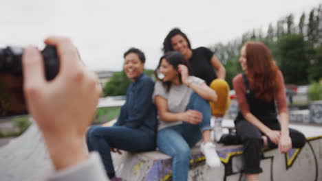 Group-Of-Female-Friends-Posing-For-Photo-On-Camera-In-Urban-Skate-Park