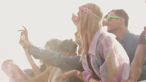Group-Of-Young-Friends-Dancing-Behind-Barrier-At-Outdoor-Music-Festival