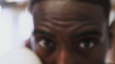 Close-Up-On-Eyes-And-Face-Of-Male-Boxer-As-He-Trains-In-Gym