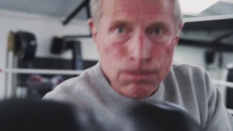 Point-Of-View-Shot-Of-Senior-Male-Boxing-Coach-In-Gym-Sparring-In-Boxing-Ring