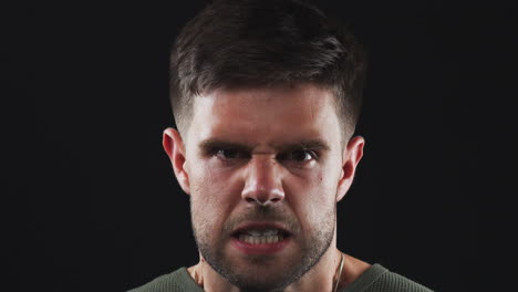 Head-And-Shoulders-Studio-Shot-Of-Angry-Man-Shouting-At-Camera-In-Slow-Motion