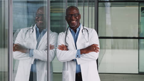 Portrait-Of-Male-Doctor-Wearing-White-Coat-And-Stethoscope-Standing-In-Modern-Hospital-Building