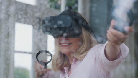 View-Through-Window-As-Mature-Woman-Wears-Virtual-Reality-Headset-And-Holds-Gaming-Controllers