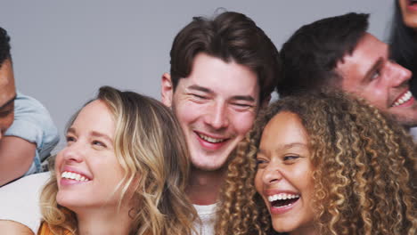 Group-Studio-Shot-Of-Young-Multi-Cultural-Friends-Smiling-And-Laughing-At-Camera-In-Slow-Motion