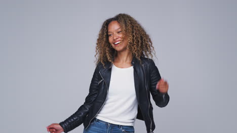 Wide-Angle-Studio-Shot-Of-Young-Woman-Wearing-Leather-Jacket-Dancing-In-Slow-Motion