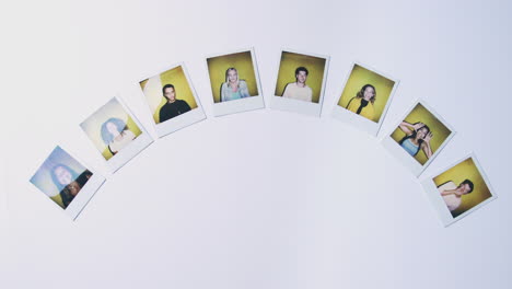 Fan-Of-Instant-Film-Photos-Of-Young-Men-And-Women-Being-Pushed-Into-Pile-On-White-Background