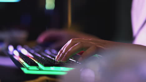 Close-Up-Of-Teenage-Girl-With-Hands-On-Illuminated-Keyboard-Gaming-At-Home-At-Night