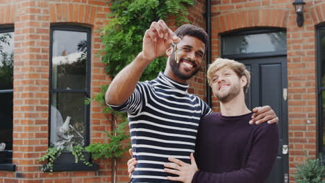 Gay-Male-Couple-Standing-Outside-New-Home-On-Moving-Day-Together-Kissing-And-Holding-Keys