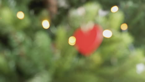 Pull-Focus-Shot-Of-Heart-Shaped-Decoration-Hanging-On-Christmas-Tree
