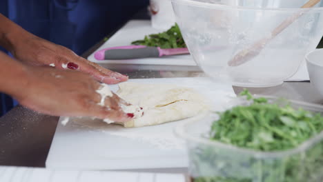 Close-Up-Of-Woman-Working-Dough-For-Dish-In-Kitchen-Cookery-Class