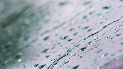 Macro-Close-Up-Shot-Of-Raindrops-Falling-On-Car-Windshield