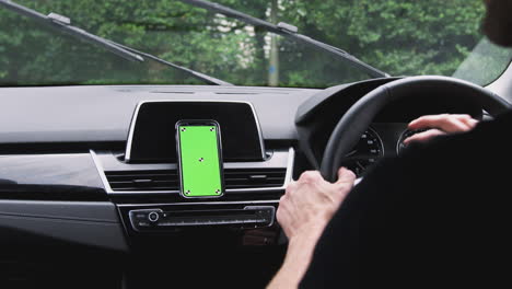 Close-Up-Of-Man-Driving-Car-With-Mobile-Phone-Mounted-On-Dashboard-Shot-In-Slow-Motion