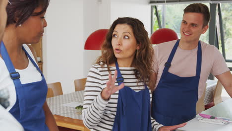 Male-And-Female-Adult-Students-Taking-Part-In-Cookery-Class-In-Kitchen