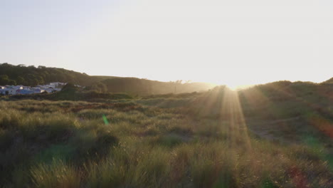 Drone-Shot-Of-Beautiful-Evening-Sun-Setting-Over-Sand-Dunes