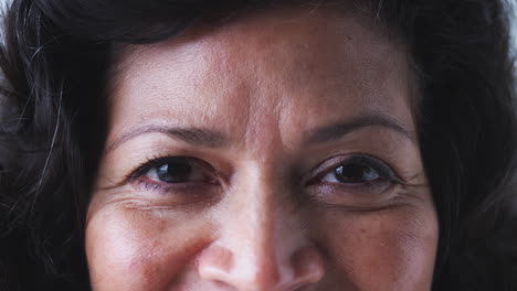 Close-Up-On-Eyes-Of-Smiling-Mature-Woman-In-Studio