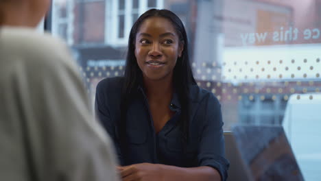Young-African-American-Businesswoman-Sitting-At-Table-In-Office-Meeting-Room