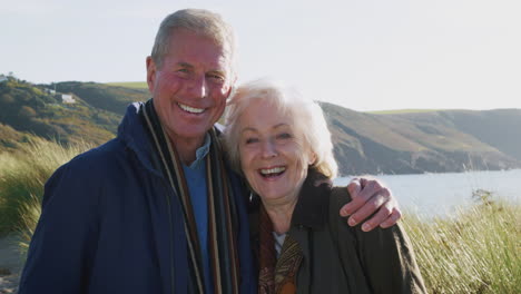 Portrait-Of-Loving-Active-Senior-Couple-They-Walk-Along-Coastal-Path