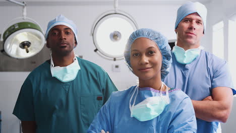 Portrait-Of-Multi-Cultural-Surgical-Team-Standing-In-Hospital-Operating-Theater
