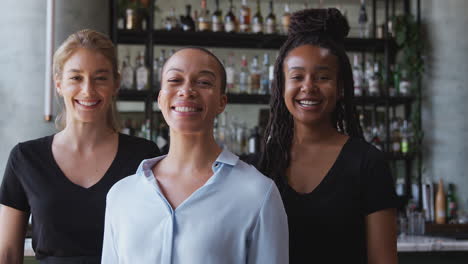 Portrait-Of-Female-Owner-Of-Restaurant-Bar-With-Team-Of-Female-Waiting-Staff-Standing-By-Counter