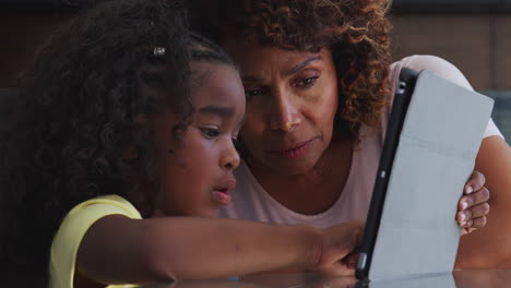Nahaufnahme-Einer-Afroamerikanischen-Großmutter-Und-Enkelin-Zu-Hause,-Die-Gemeinsam-Ein-Digitales-Tablet-Nutzen
