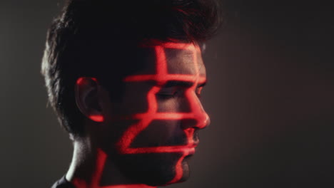 Facial-Recognition-Technology-Concept-As-Man-Has-Red-And-Green-Grids-Projected-Onto-Eye-In-Studio