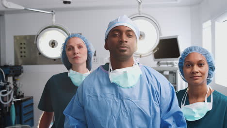 Portrait-Of-Multi-Cultural-Surgical-Team-Standing-In-Hospital-Operating-Theater