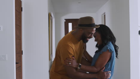 Smiling-African-American-Couple-Talking-And-Laughing-In-Hall-At-Home