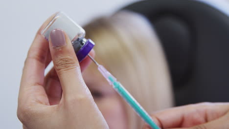 Close-Up-Of-Beautician-Or-Doctor-Filling-Syringe-Before-Giving-Patient-Botox-Injection