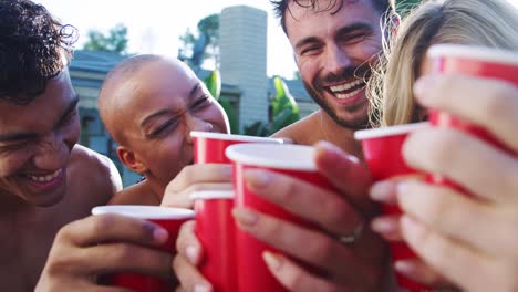 Group-Of-Friends-With-Drinks-Outdoors-Relaxing-In-Swimming-Pool-And-Enjoying-Summer-Pool-Party