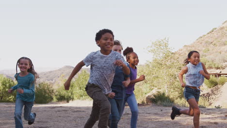 Group-Of-Multi-Cultural-Children-With-Friends-RunnIng-Towards-Camera-In-Countryside-Together