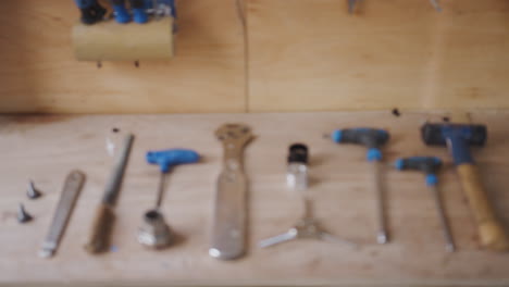 Close-Up-Of-Carpentry-Tools-On-Workbench-In-Workshop-Pulled-Into-Focus