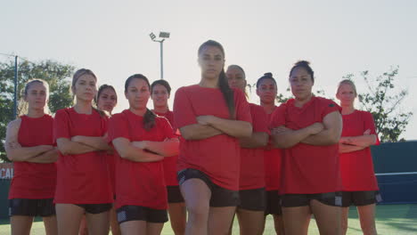 Portrait-Of-Determined-Female-Soccer-Team-On-Training-Ground-Against-Flaring-Sun
