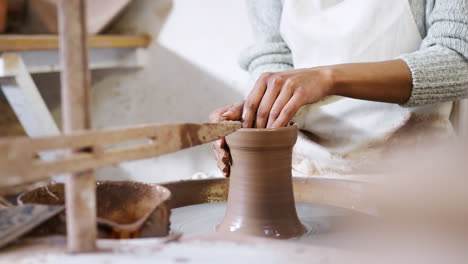 Close-Up-Of-Young-African-American-Woman-Working-At-Pottery-Wheel-In-Ceramics-Studio