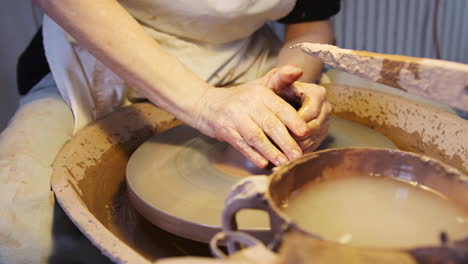 Close-Up-Of-Male-Potter-Throwing-Clay-For-Pot-Onto-Pottery-Wheel-In-Ceramics-Studio