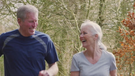 Senior-Couple-Running-In-Countryside-Exercising-During-Covid-19-Lockdown