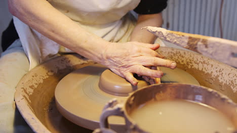 Close-Up-Of-Male-Potter-Shaping-Clay-On-Pottery-Wheel-In-Ceramics-Studio