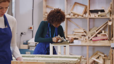 Tutor-With-Female-Carpentry-Student-In-Workshop-Studying-For-Apprenticeship-At-College