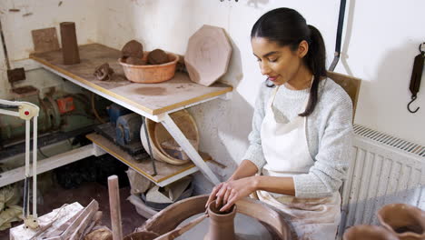 Young-African-American-Woman-Working-At-Pottery-Wheel-In-Ceramics-Studio