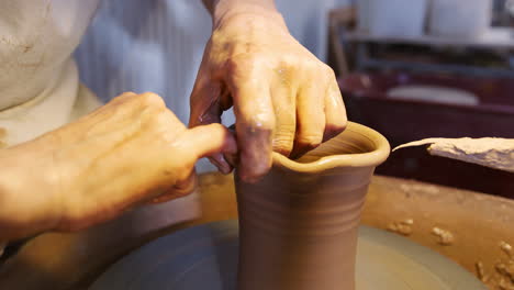 Close-Up-Of-Male-Potter-Shaping-Neck-Of-Clay-Vase-On-Pottery-Wheel-In-Ceramics-Studio