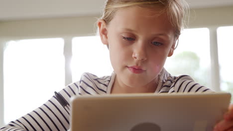 Girl-At-Table-With-Digital-Tablet-Home-Schooling-During-Health-Pandemic