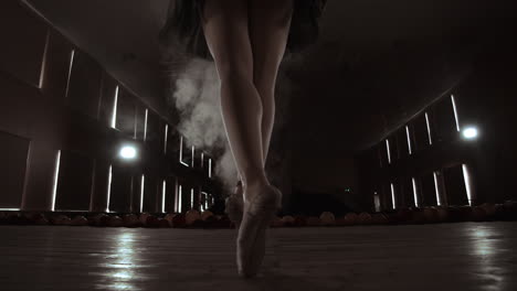 Close-up-Shot-of-Ballerina's-Legs.-She-Dances-on-Her-Pointe-Ballet-Shoes.-She's-Wearing-Black-Tutu-Dress.-Shot-in-a-Bright-and-Sunny-Studio.-In-Slow-Motion.