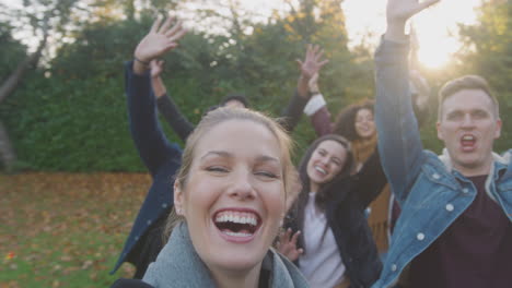 Portrait-Of-Multi-Cultural-Group-Of-Friends-Posing-For-Selfie-On-Outdoor-Walk-In-Countryside